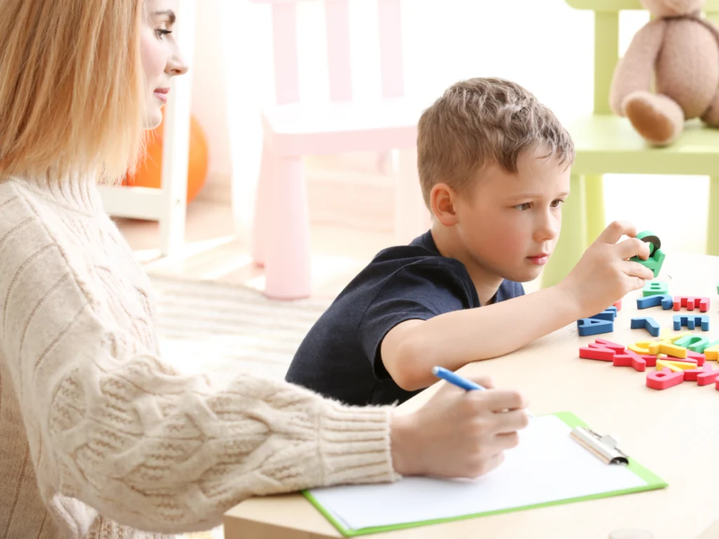 Nurse on therapy with autistic child