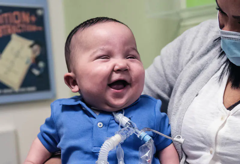 Nurse taking care of a child with tracheostomy